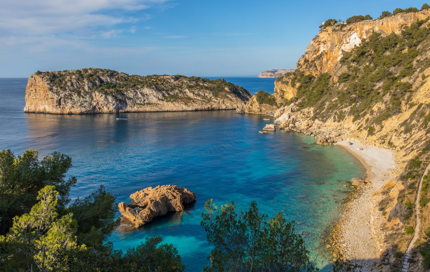 Cala Ambolo beach below Cap Negre in Javea with the Illa del Descobridor offshore